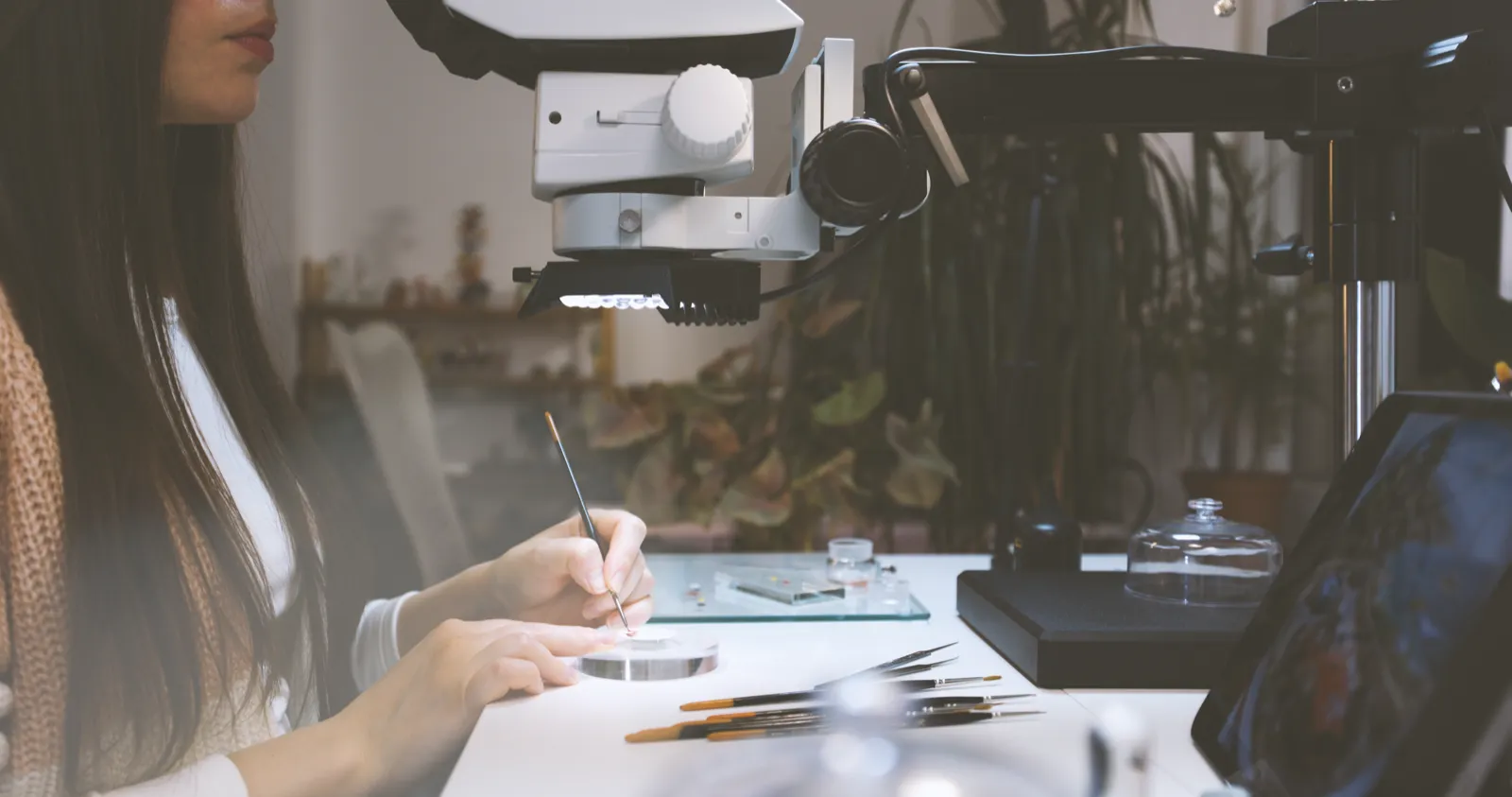 EGGcraft artist painting a dial under the microscope